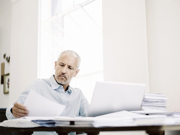man looking into papers