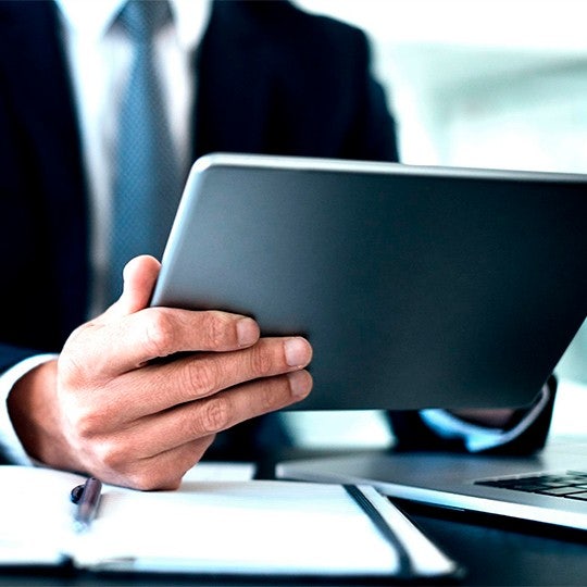 man looking into his tablet